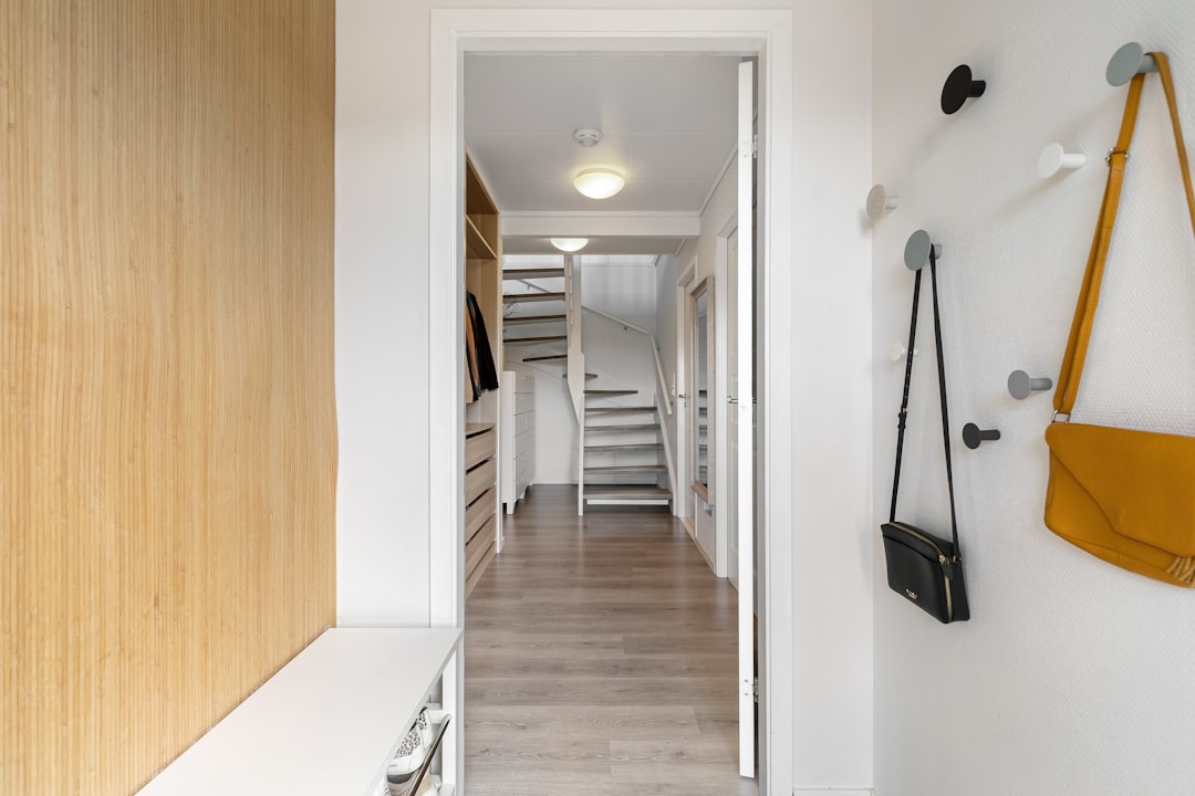 A clear pathway leads to the front door of a stunning, modern home on a sunny day, symbolizing a successful future home sale.