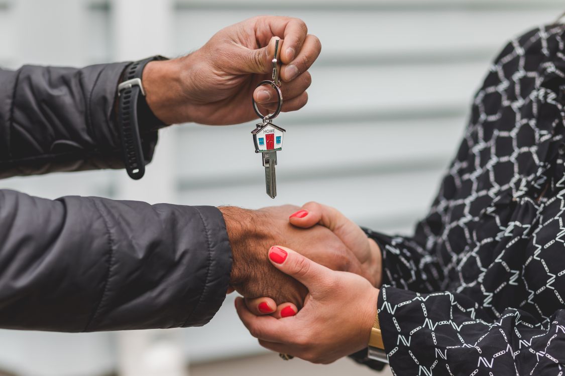 A close-up of a person's hands carefully reviewing a contract with a pen, highlighting the new importance of negotiation in home selling.
